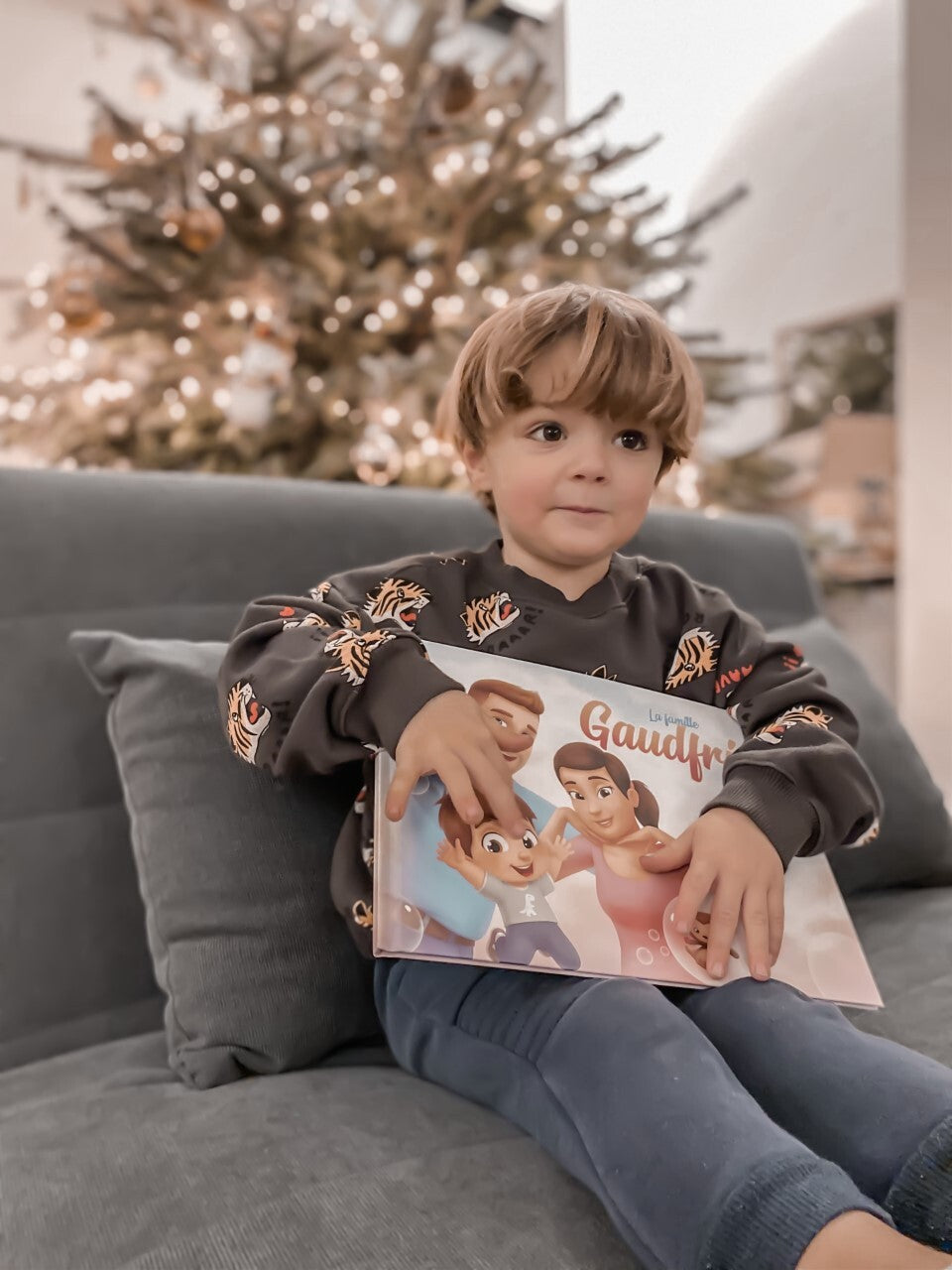 Un petit garçon sur le point de lire son livre personnalisé pour les familles, rempli d'aventures originales.